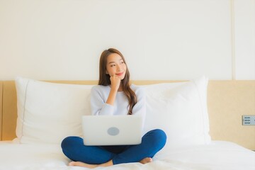 Portrait beautiful young asian woman use computer laptop on bed