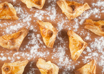 Freshly baked khachapuris with cheese on a wooden table.