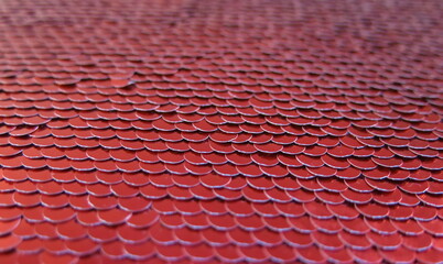 Red beautifully laid out sequins in the form of fish scales © NADEZHDA