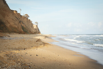 Fototapeta na wymiar Sea with waves on beautiful sandy beach