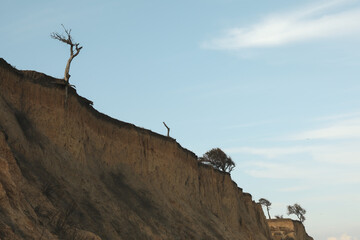 Clay slopes against blue sky, space for text