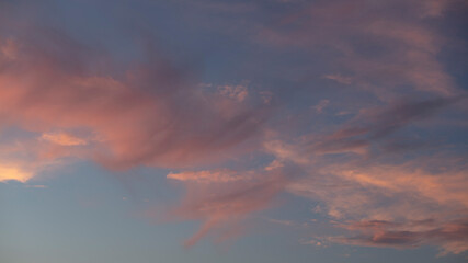 Beautiful pink clouds during sunset, blue sky with clouds background.	