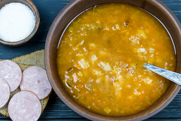 Soup with black bread and sausage