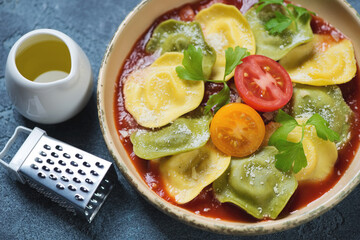 Close-up of italian ravioli with tomato sauce and grated parmesan cheese, studio shot