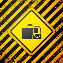 Black Suitcase for travel icon isolated on yellow background. Traveling baggage sign. Travel luggage icon. Warning sign. Vector.