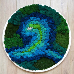 round panel from colored stabilized moss on a wooden background