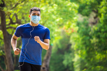  man in face mask and running in the park