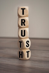 Cubes, dice or blocks with trust and truth on wooden background