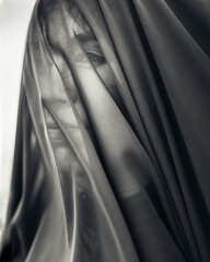 Portrait of woman under transparent textile