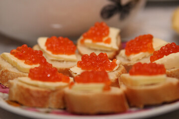 sandwiches with red caviar on the home table
