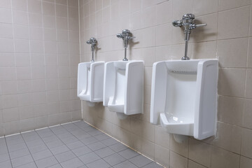 Three Urinals in public toilet
