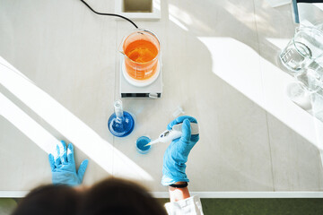 Person working in laboratory preparation test samples for medical research, close-up - 388223109