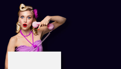 Shocked or very happy woman with phone and blank signboard, over black background