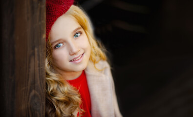 Cute little girl in red beret in autumn