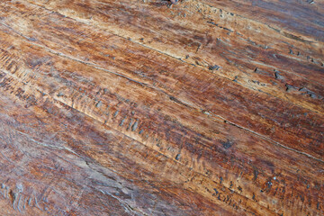 Wooden board of a rustic table view in close up from top