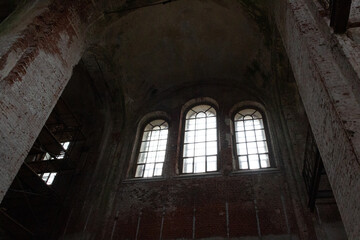 interior of the old abandoned and renovating brick church in russian village Sergeevo in day light