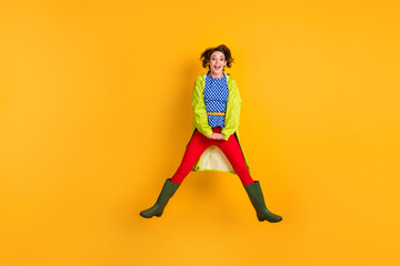 Fototapeta na wymiar Full length photo portrait of woman jumping up with hands down isolated on vivid yellow colored background