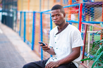 image of african guy, with smart phone- outdoor concept 