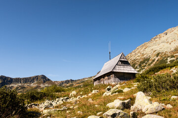 Wooden mountain hut on a glade in Five Polish Ponds Valley in Tatra Mountains, Poland.