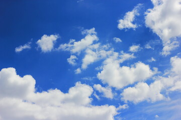 Naklejka na ściany i meble Dynamic movement of white clouds across a blue sky. Concept movement, spring weather, easter