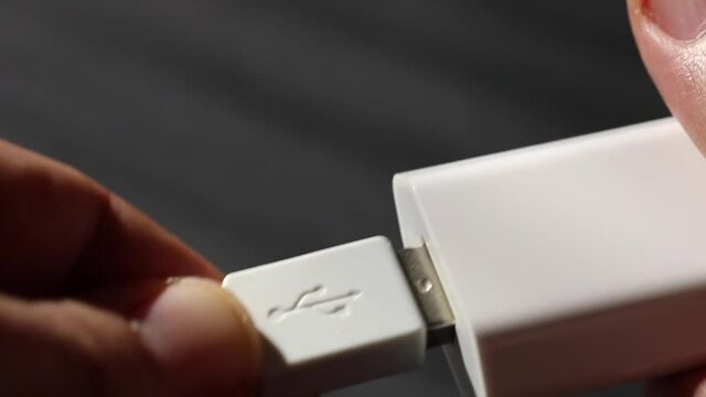 putting an usb cable in charging adapter 