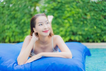 Portrait beautiful young asian woman relax smile around outdoor swimming pool