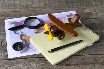 The set of objects about concepts of travel, tourism and transportation are on the gray wooden background. 