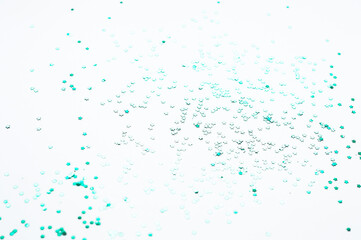 Color confetti in the shape of stars on a white paper background.