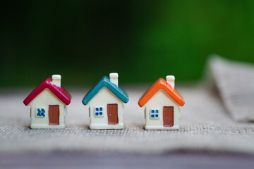 Mini house on green nature background,   Mortgage concept, Real estate investment, Real estate...