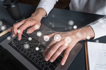 Man using computer. Hands typing laptop. Double exposure with abstract technology network hologram. Close up. Datum concept.