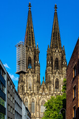 Fototapeta na wymiar Germany, Cologne, Autun Cathedral, a view of a large church with Autun Cathedral in the background