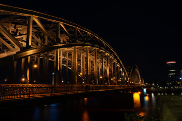 Germany, Cologne, a large bridge lit up at night