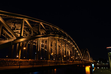 Germany, Cologne, a large bridge lit up at night