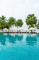 empty beach chair around swimming pool