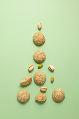 Soft amaretti with pistachios. Traditional italian almond cookies lie in form Christmas tree. Gluten-free bakery product