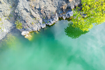 a beautiful lake with stone banks background from above