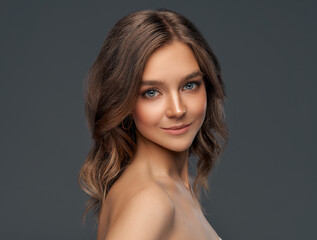 Beauty portrait of young model with long curly hair