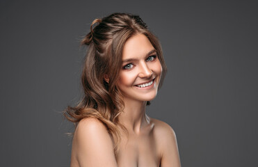 Fototapeta premium Portrait of cheerful young model isolated on gray backgroud