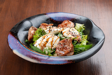 Duck breast salad with cream cheese and arugula. In a decorative plate