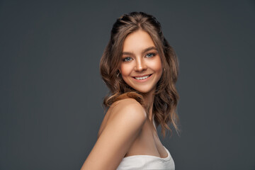 Fototapeta premium Beauty portrait of cheerful young model with long curly hair