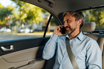 Man fastened his seat belt and using phone.