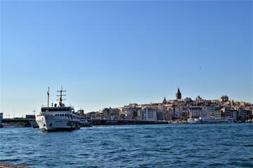 Fototapeta premium Panoramic View in Mega City Istanbul. Marmara sea and public transportation ship with Galata Tower background.