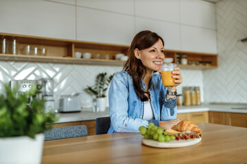 Smiling woman, at home, enjoying.