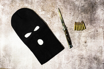 black thieving balaclava with automatic knife and war bullets