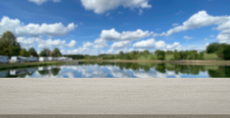 empty stone product display background RV park Mobilehome blur blue sky with clouds and lake. can used for mock up products