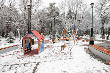 Naklejka premium Playground under the snow, first snow