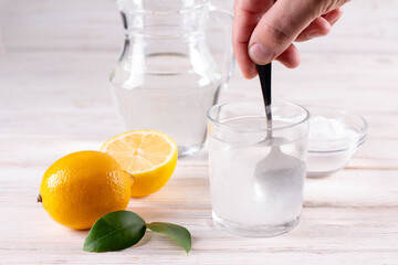 Collagen protein powder - Hydrolyzed. Spoon, lemon and glass of water. Extra protein intake