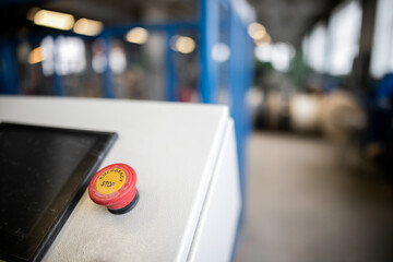 Close up emergency stop button on control panel of machine for safety at factory