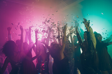Fototapeta na wymiar Photo of big group many fancy ladies dance raise hands falling confetti neon vibrant spotlight modern club indoors