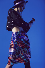 Posing model in multi skirt and black top